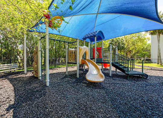 Pet-Friendly Apartments in Coconut Creek, FL – Waterview at Coconut Creek – playground with a slide and other playground equipment