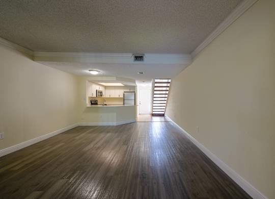 Apartments In Coconut Creek for Rent – Waterview at Coconut Creek – living room with wood floors and a staircase