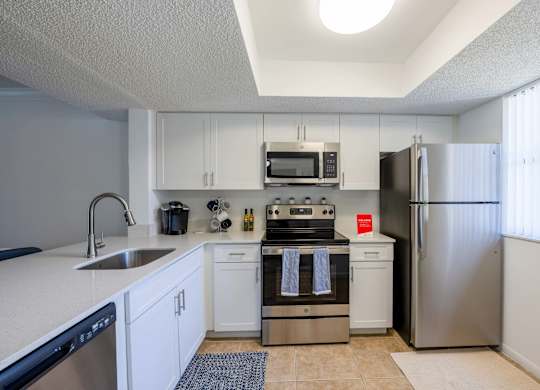 Coconut Creek Apartments – Waterview at Coconut Creek – kitchen with white cabinets and stainless-steel appliances
