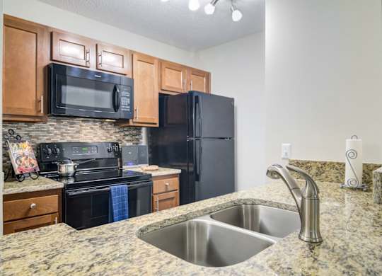 West Marietta, GA Apartments – Wood Pointe Apartments – A kitchen with black appliances