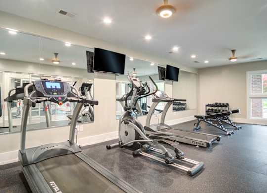 Pet-Friendly Apartments in Marietta– Wood Pointe Apartments – A gym with treadmills, elliptical machines, and a flat screen TV.