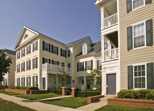 a picture of a row of townhomes with a blue sky in the background at The Residences at King Farm, Rockville