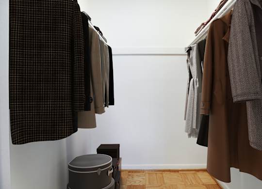 A row of coats hanging on a rack.