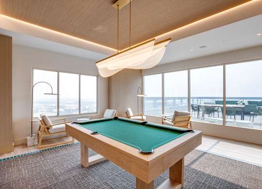 Newly renovated rooftop resident lounge with pool table at Lenox Club Apartments in National Landing, VA 22202