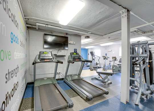 Fitness center with treadmills at Mason Hall in Alexandria, VA 22314