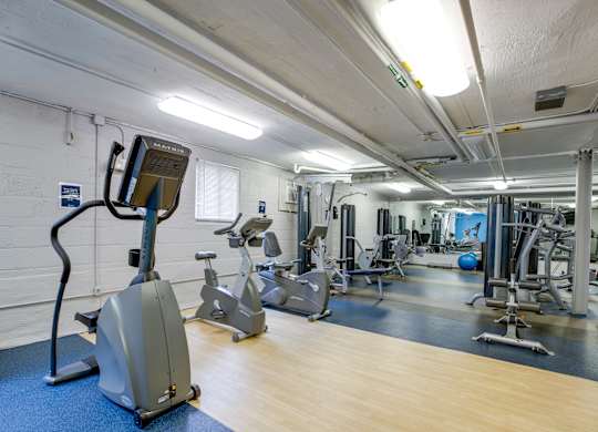 Fitness center with cardio and strength training equipment at Mason Hall in Alexandria, VA 22314