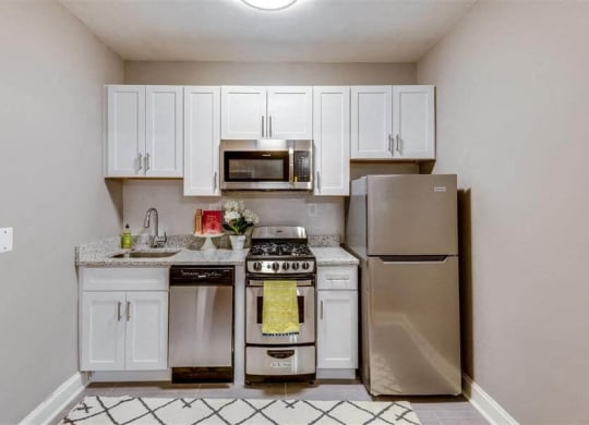 Studio apartment kitchen with stainless steel appliances at The York and Potomac Park, Washington, Washington