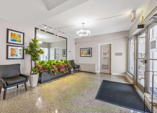 a lobby with a large mirror and a black chair