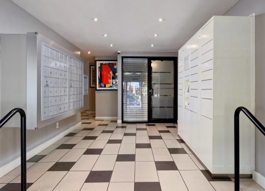 a locker room with white cabinets and a black door