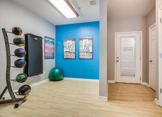 a home gym with a blue wall and a treadmill at The Residences at King Farm, Rockville, 20850