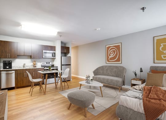 a living room and kitchen with a couch and chairs and a table at Residences at Rio, Gaithersburg, MD, 20878