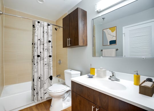 a bathroom with a shower toilet and sink and a mirror at Residences at Rio, Gaithersburg, MD, 20878