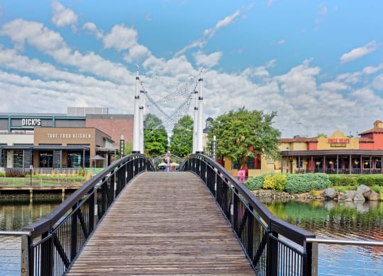 a bridge over a body of water with buildings on either side at Residences at Rio, Maryland