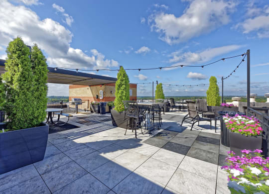an outdoor patio with tables and chairs and awning