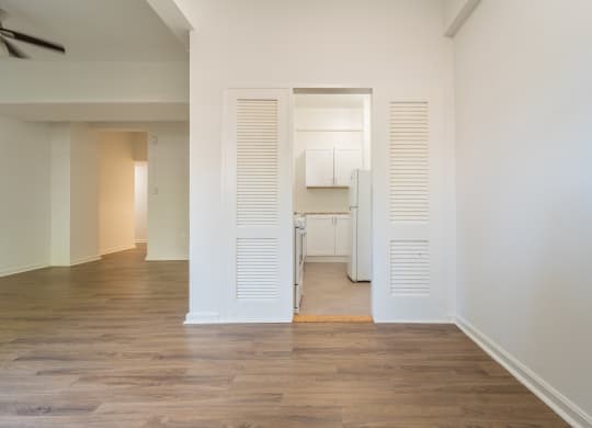a bedroom with a medium hardwood floor and white walls