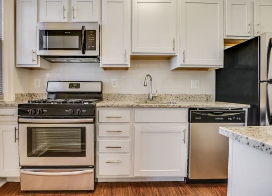 Renovated kitchen with stainless steel appliances and granite countertops  at Kew Gardens, Washington, DC