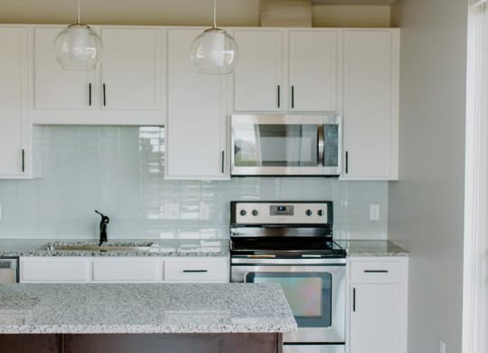 Fully Equipped Kitchen Includes Frost-Free Refrigerator, Electric Range, & Dishwasher at Hello Apartments, Minneapolis, 55427