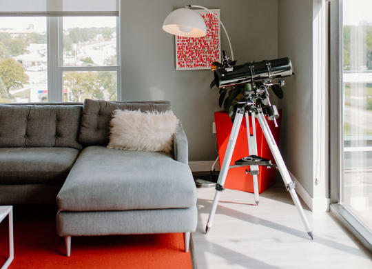 Living Room With Telescope at Hello Apartments, Minneapolis