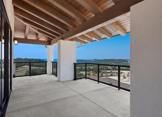 a balcony with a view of the city and the mountains