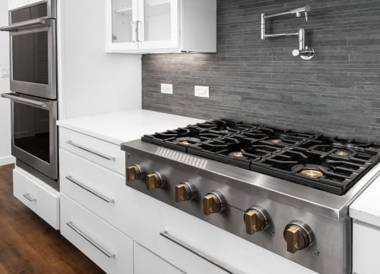 a kitchen with a stove top oven and a sink