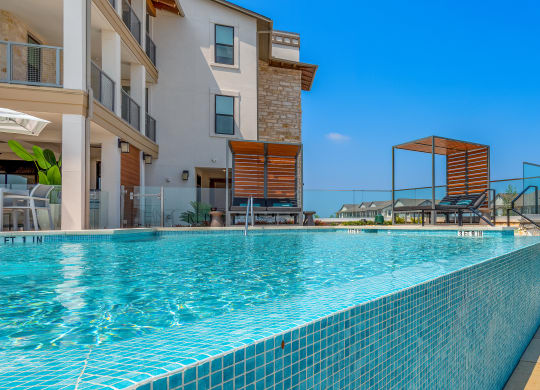 a swimming pool with a building in the background