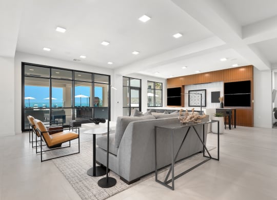 a large living room with a gray couch and a table