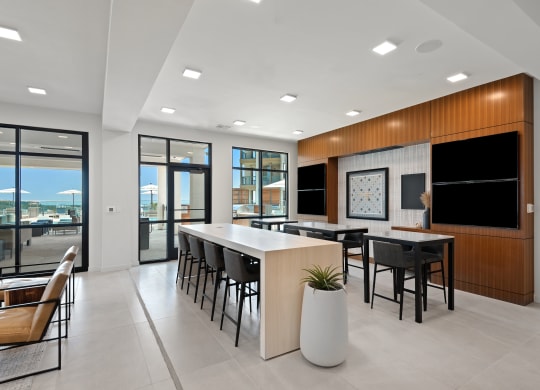 a communal area with a table and chairs in a modern office space