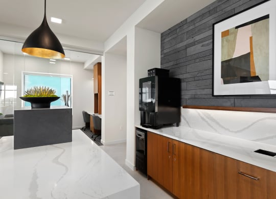 a kitchen with a marble counter top and a black tv