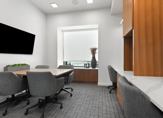 a conference room with a table and chairs