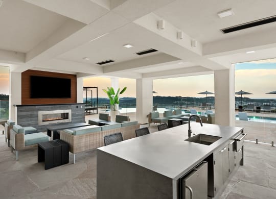 a large kitchen and living room with a view of a swimming pool