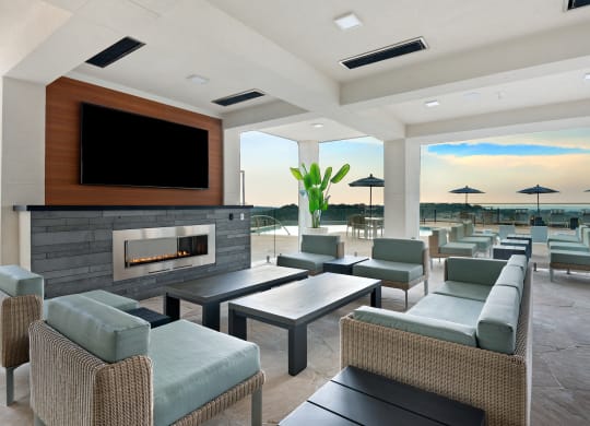 a lounge area with couches and chairs and a fireplace