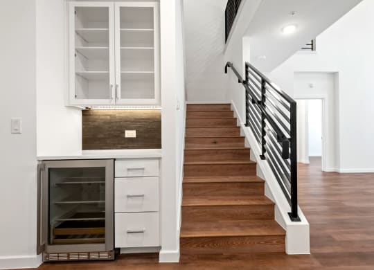 a view of a staircase in a home with white walls and wood floors