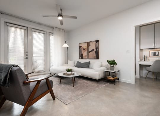 a living room with a white couch and a chair