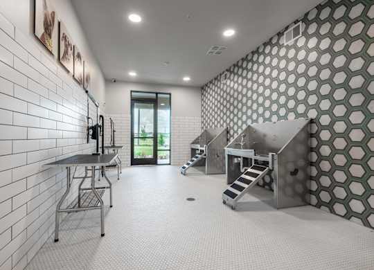 A white tiled hallway with a staircase and a door.