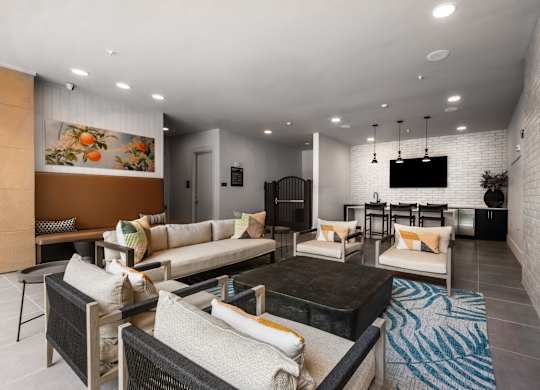 A modern living room with a black coffee table and white sofas.