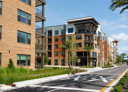 A street view of a residential area with modern buildings.