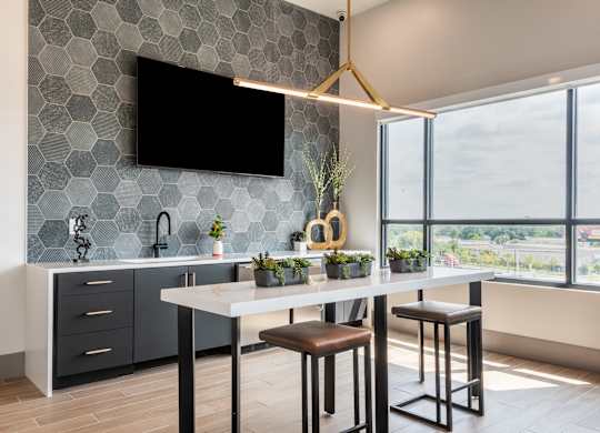 A modern kitchen with a bar stool and a countertop.