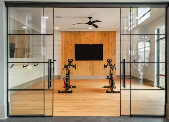 A room with a wooden wall and a television mounted on it.