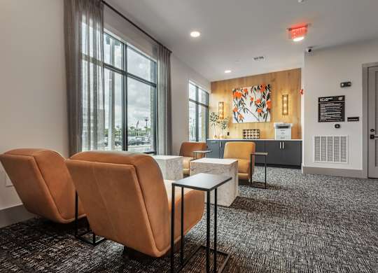 A room with orange chairs and a wooden wall with a mural.