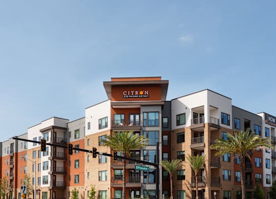 A modern apartment complex with the name "Citron" on the top floor.