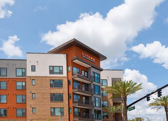 A multi-story building with a sign that reads "Citizen" on the top floor.