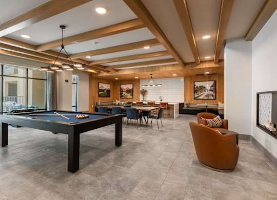 A room with a pool table and a couch.