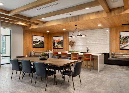 A dining room with a wooden table and chairs.
