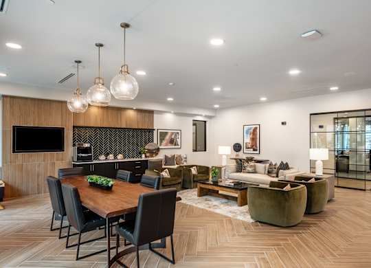 A modern living room with a wooden dining table and chairs.