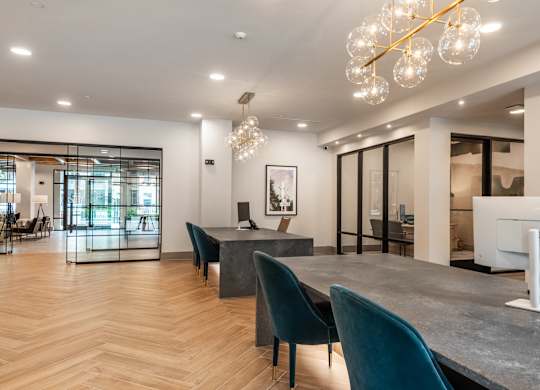 A modern dining room with a large table and chairs.