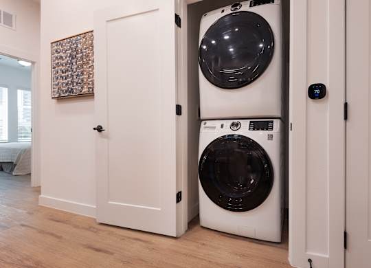 A white washing machine is in a doorway.