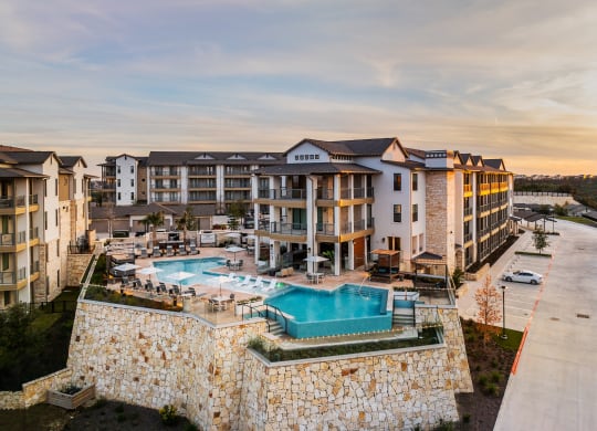 an aerial view of an apartment building with a swimming pool