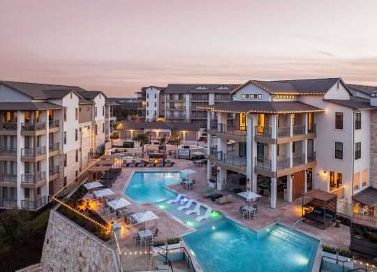 an aerial view of an apartment complex with a swimming pool