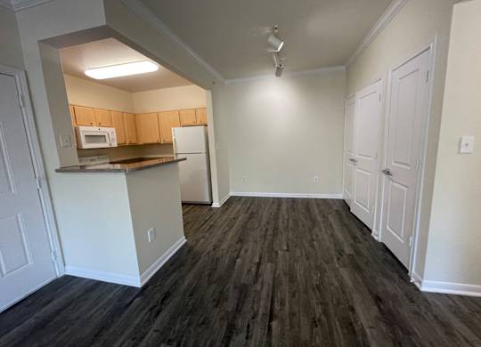 A kitchen area with a microwave, oven, and refrigerator.