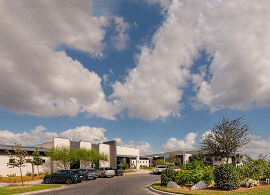 A large building with a parking lot in front of it.